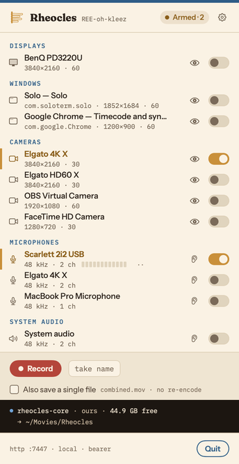 The Rheocles menu bar popover. Displays, windows, cameras and microphones are listed with a switch each; the Elgato 4K X camera and the Scarlett 2i2 microphone are armed, the BenQ display and two windows are listed but not. The take bar is idle: a Record button, a take name field, and an unticked Also save a single file.